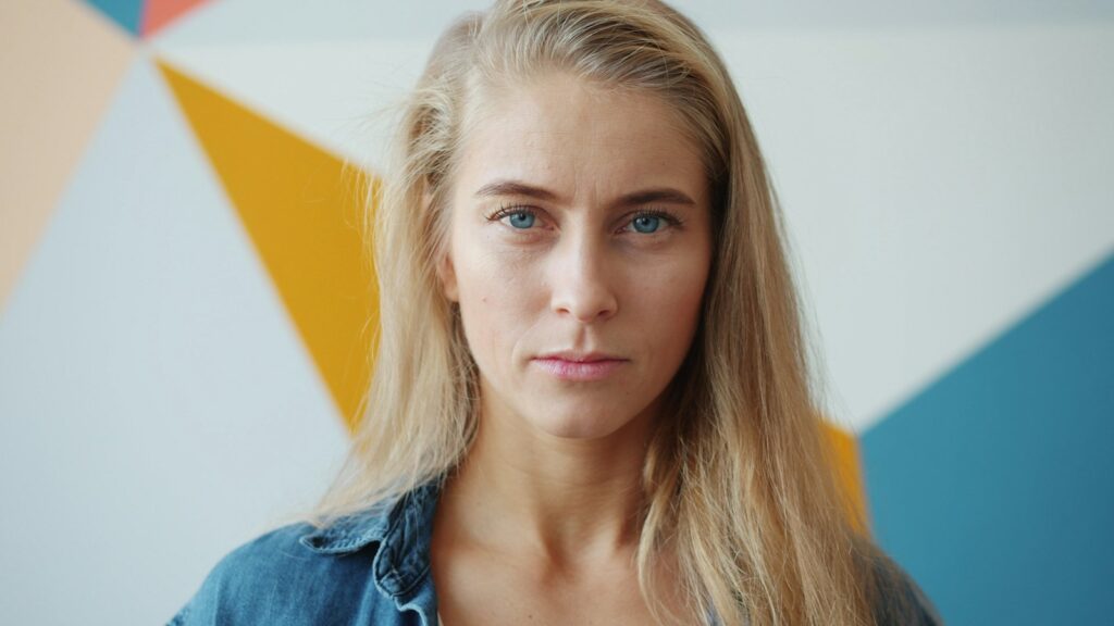 Woman with a relaxed, neutral expression and level mouth corners