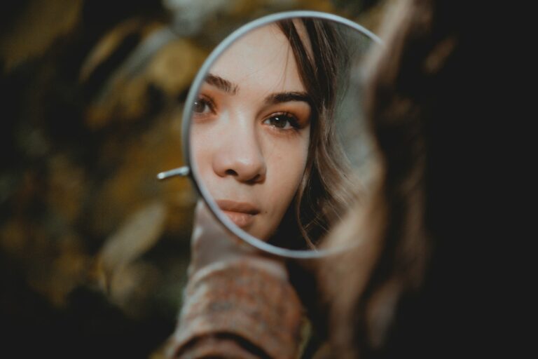 Woman checking her brows in a mirror after Botox gone wrong