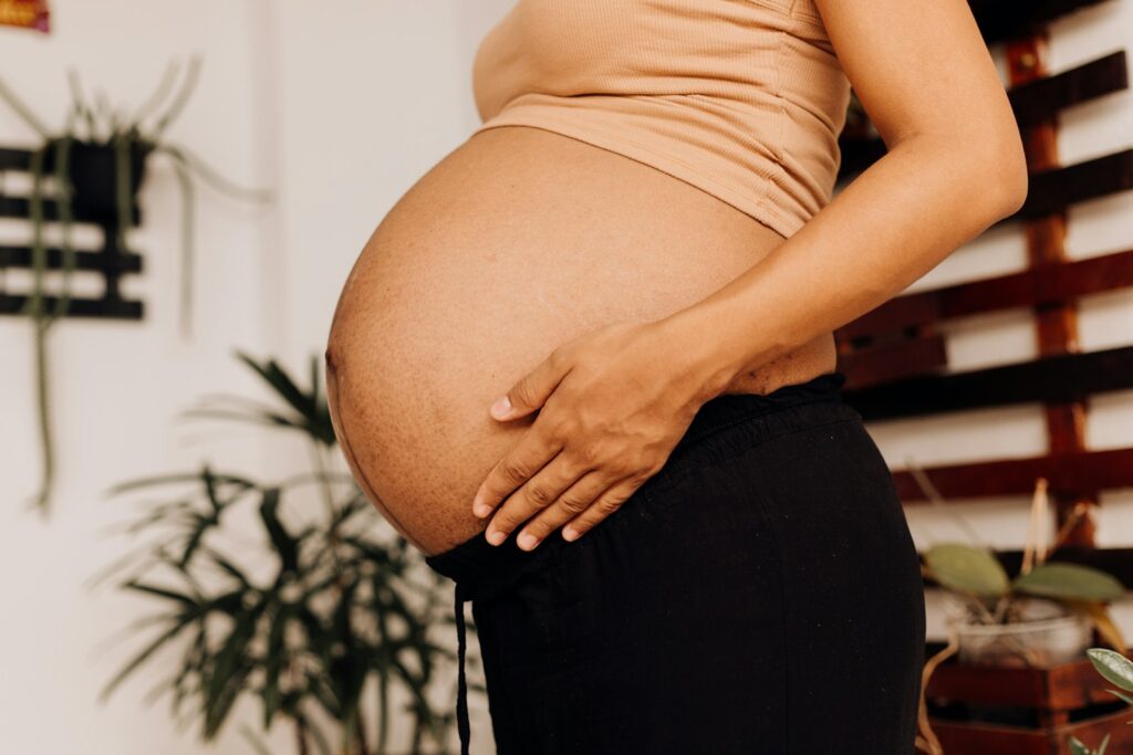 Pregnant woman resting on a couch at home