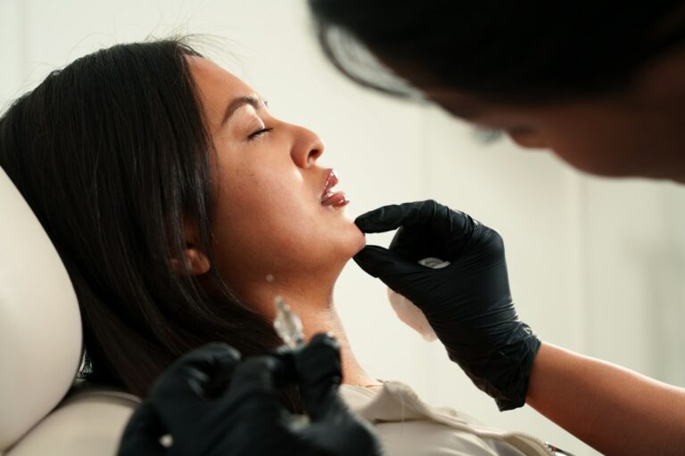 Injector treating a patient's lips, illustrating lip filler cost in Orlando