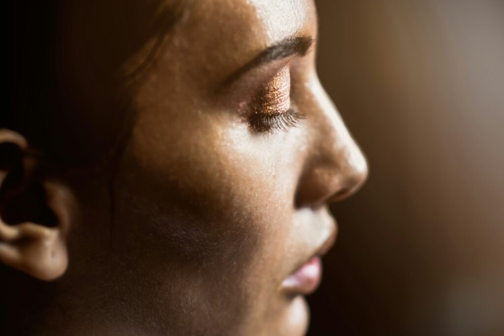 Profile view of a woman's face showing the brow, nose, and cheek areas