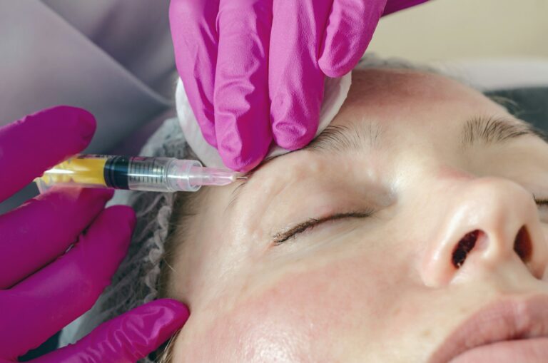 Nurse practitioner treating a patient's forehead, illustrating when does Botox k | LightTouch Med Spa Nurse practitioner treating a patient's forehead, illustrating when does Botox kick in after injections