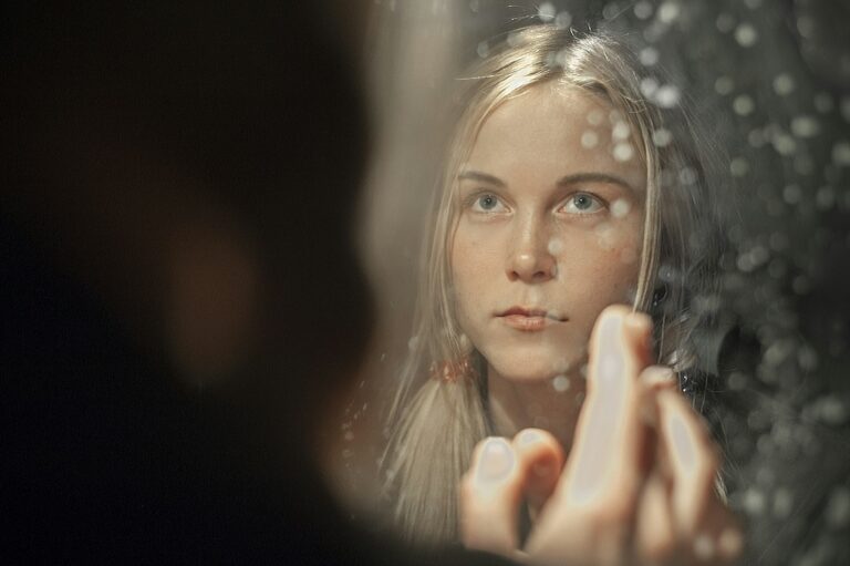 Woman checking her frown lines in a mirror, wondering why her Botox stopped working
